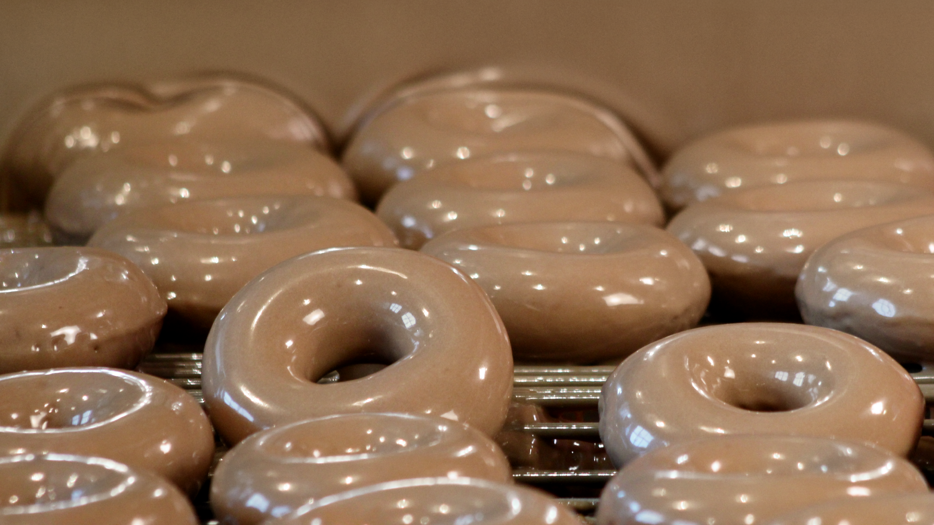 Krispy Kreme coffee flavored doughnuts on a rack